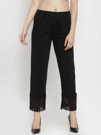 Black viscose lace palazzo pants with intricate hem detailing.