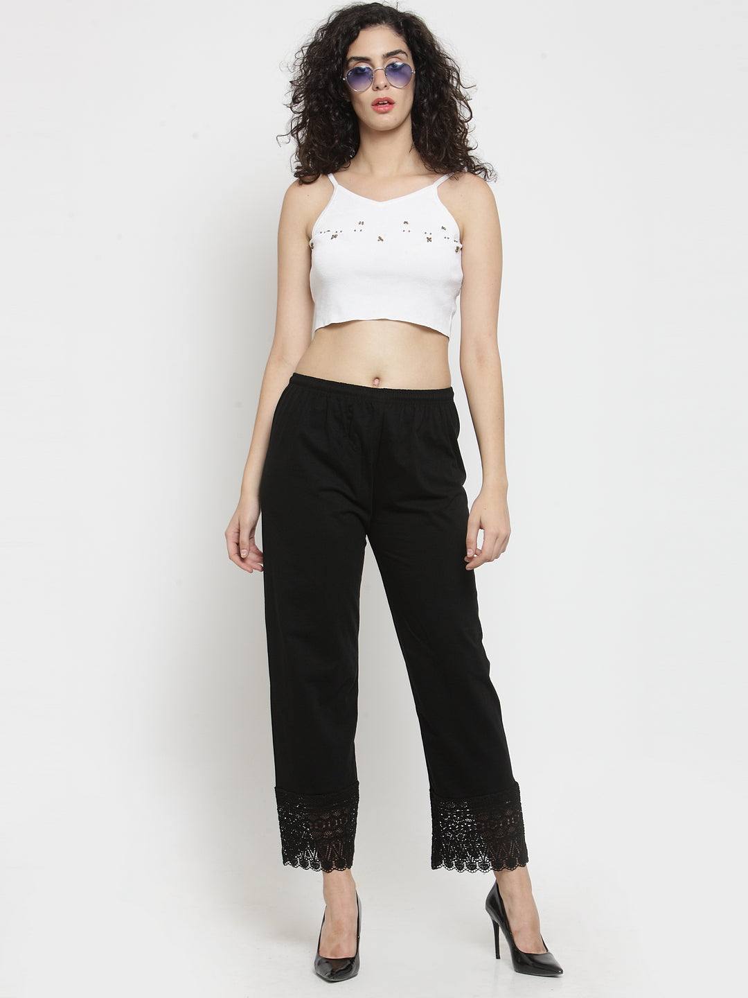Black viscose lace palazzo paired with a white top, featuring stylish lace detailing at the hem.