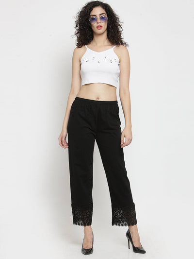 Black viscose lace palazzo paired with a white top, featuring stylish lace detailing at the hem.