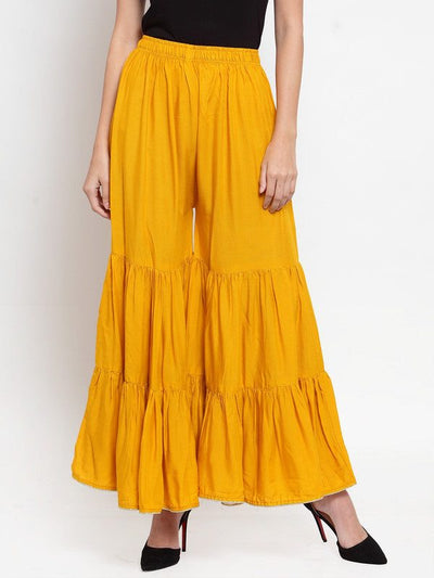 Mustard flared solid gharara with golden gota hem and rayon fabric.