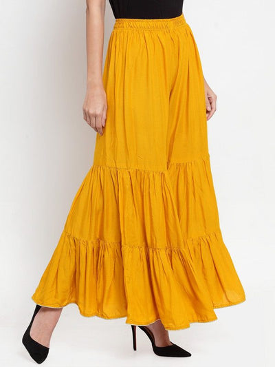 Mustard flared solid gharara with golden gota hem detailing, made from lightweight rayon fabric.