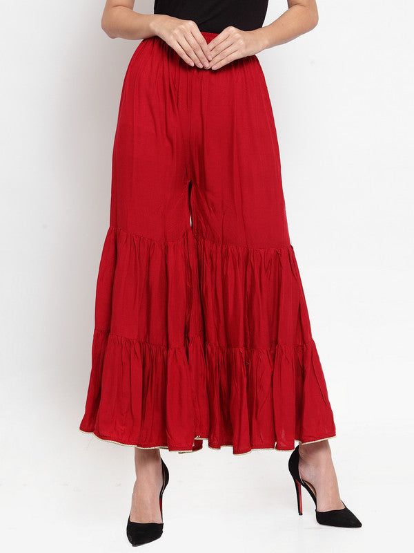Maroon flared solid gharara with golden gota hem and rayon fabric.