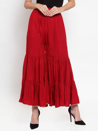 Maroon flared solid gharara with golden gota hem and rayon fabric.