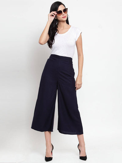 Navy blue solid rayon culottes styled with white top and heels.