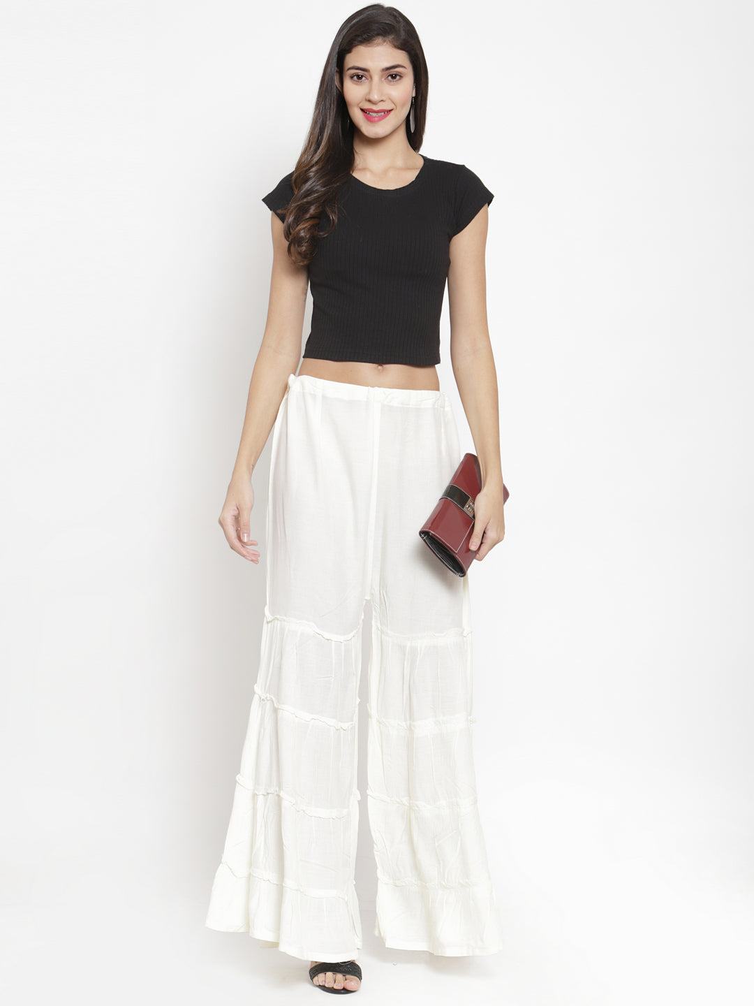 Cream flared solid Gharara styled with black top and clutch for a casual classy look.