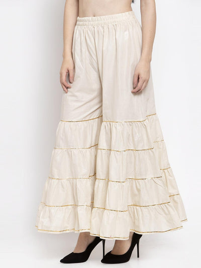 Off-White Gotta Patti Cotton Gharara with elastic waistband, styled with black heels.