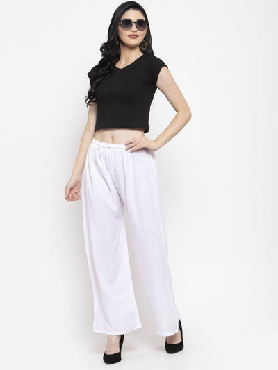 White solid rayon palazzo with elasticated waistband, paired with a black top and heels.