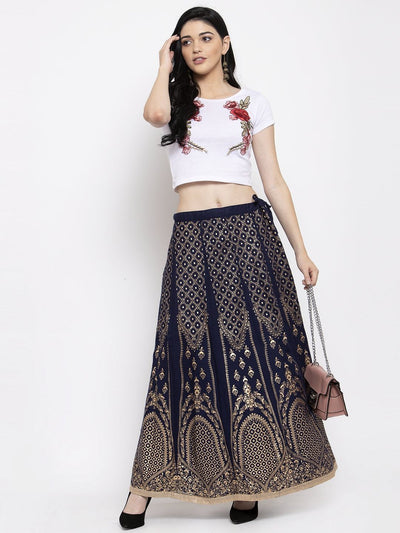 Black printed flared rayon skirt with intricate patterns, styled with a white top and high heels.