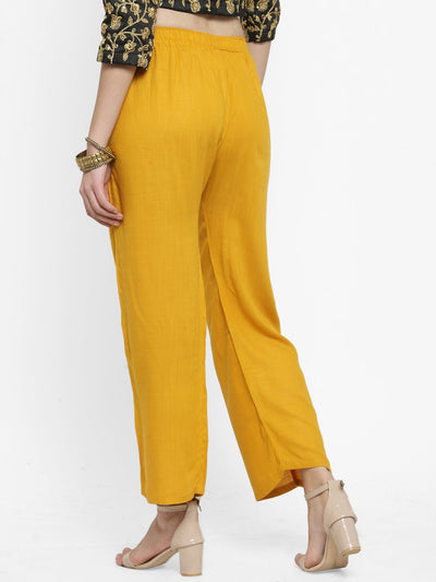 Solid mustard rayon palazzo pants for women, rear view.