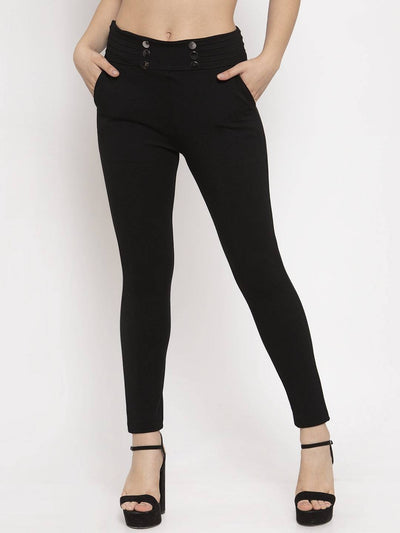 Black slim fit jeggings with button details, made from NR Roma fabric.
