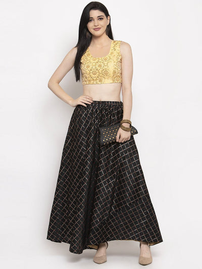 Black printed maxi skirt made of silk fabric, styled with a blouse and high heels for a chic look.