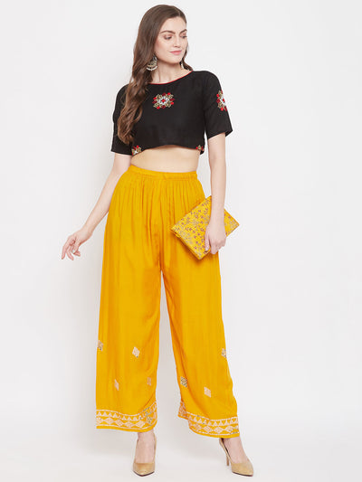 Mustard embellished rayon palazzo with mirror work and elasticated waistband.
