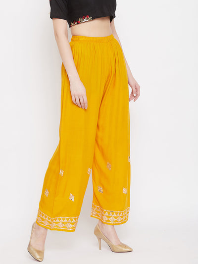 Mustard embellished rayon palazzo with mirror work and elasticated waistband.