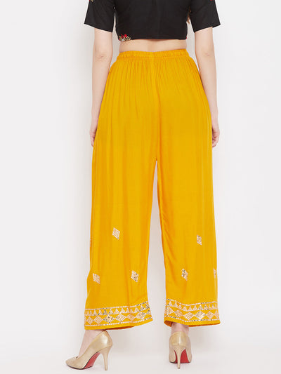 Mustard Embellished Rayon Palazzo with mirror work and elastic waistband.