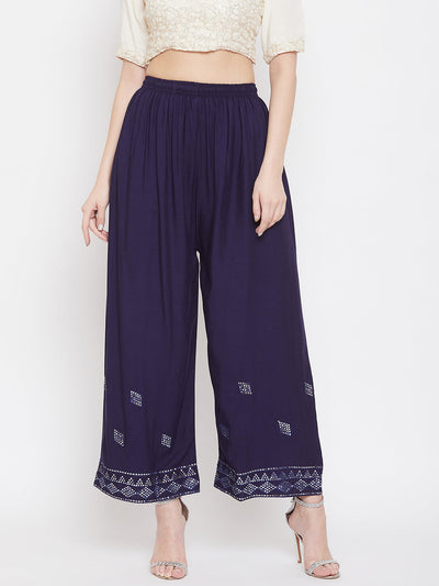 Navy blue embellished rayon palazzo with elastic waistband and mirror work hem.