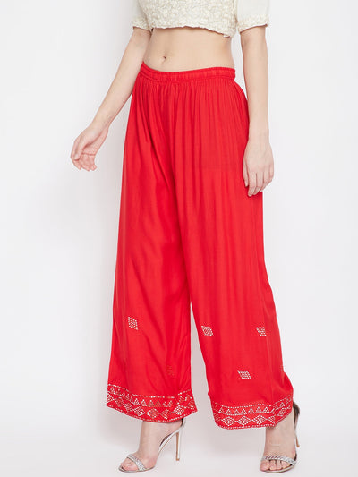 Red embellished rayon palazzo with mirror work and elasticated waistband.
