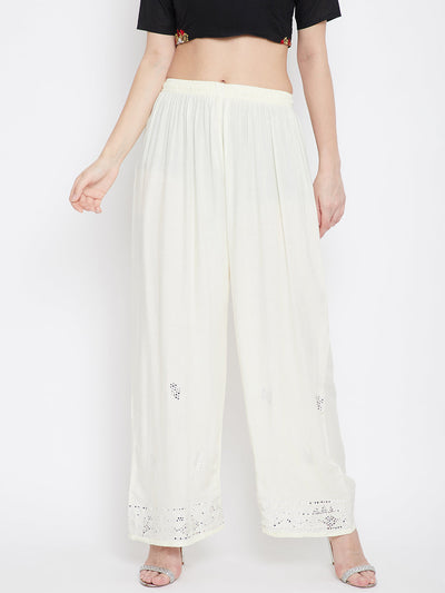 Cream embellished rayon palazzo with elasticated waistband and mirror work hem.