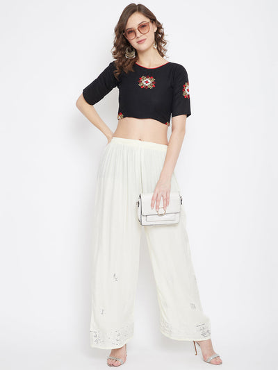 Cream embellished rayon palazzo with mirror work and elasticated waistband.