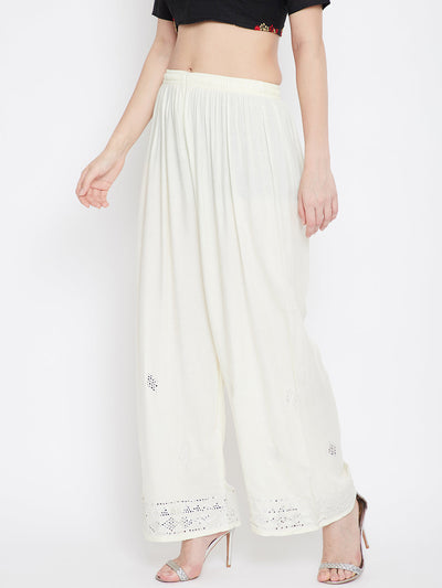 Cream embellished rayon palazzo with mirror work hem and elasticated waistband.