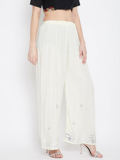 Cream embellished rayon palazzo with mirror work and elasticated waistband.