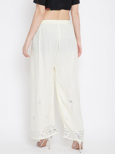 Cream embellished rayon palazzo with elasticated waistband and mirror work hem.
