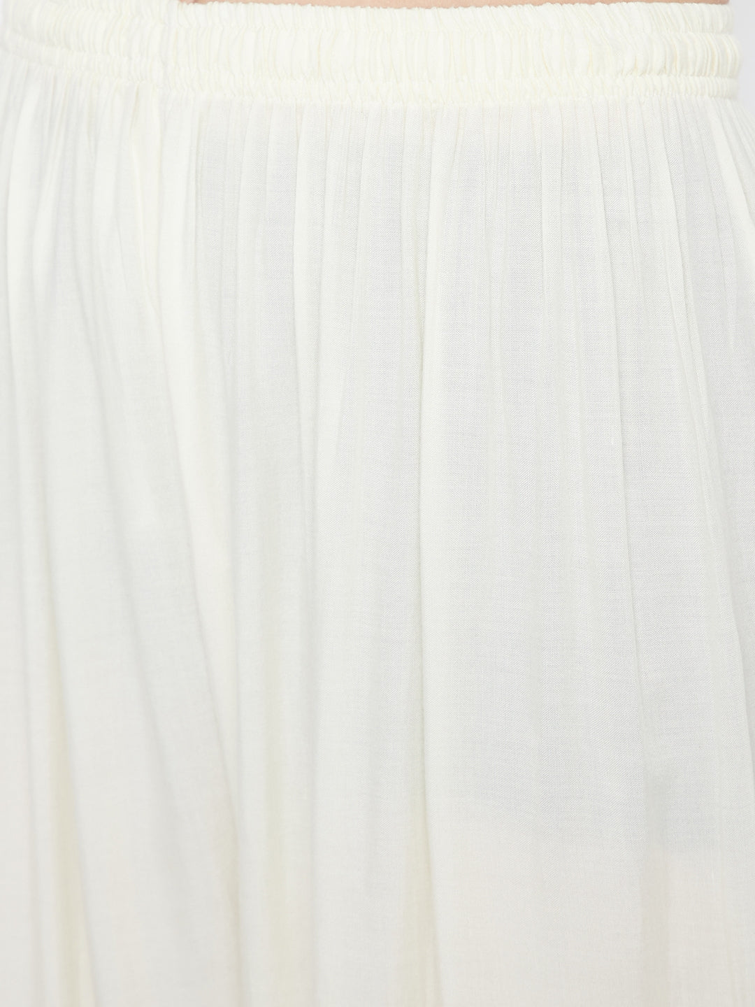 Cream embellished rayon palazzo with elasticated waistband and mirror work hem.