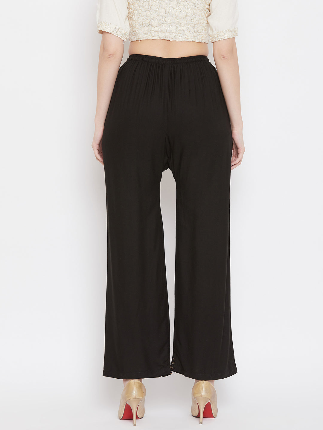 Black straight embellished palazzo with elastic waistband and stone work hem, made from rayon.