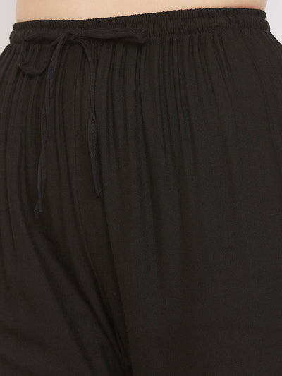 Black straight embellished palazzo with elasticated waistband and stone work.