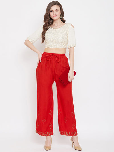 Red straight embellished palazzo with stone work on the hem and elasticated waistband.