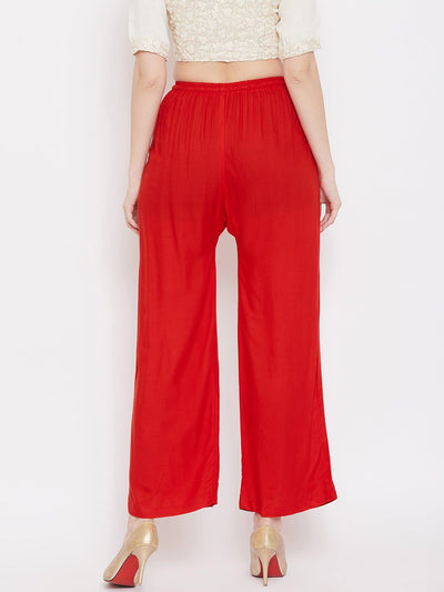 Red straight embellished palazzo with elasticated waistband and stone work on hem.