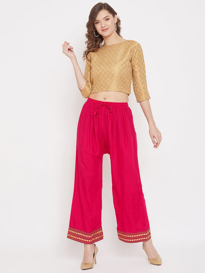 Magenta hem design embroidered straight palazzo in rayon fabric worn by a model.