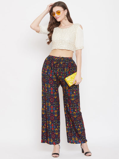 Navy blue printed rayon palazzo pants with colorful design, styled for a fashionable look.