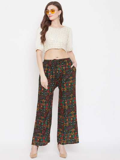 Bottle Green Printed Rayon Palazzo paired with a white crop top and beige heels.