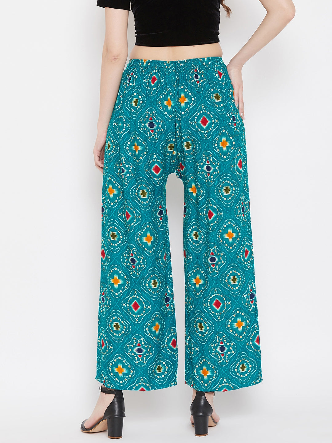 Turquoise printed rayon palazzo with vibrant patterns, back view.