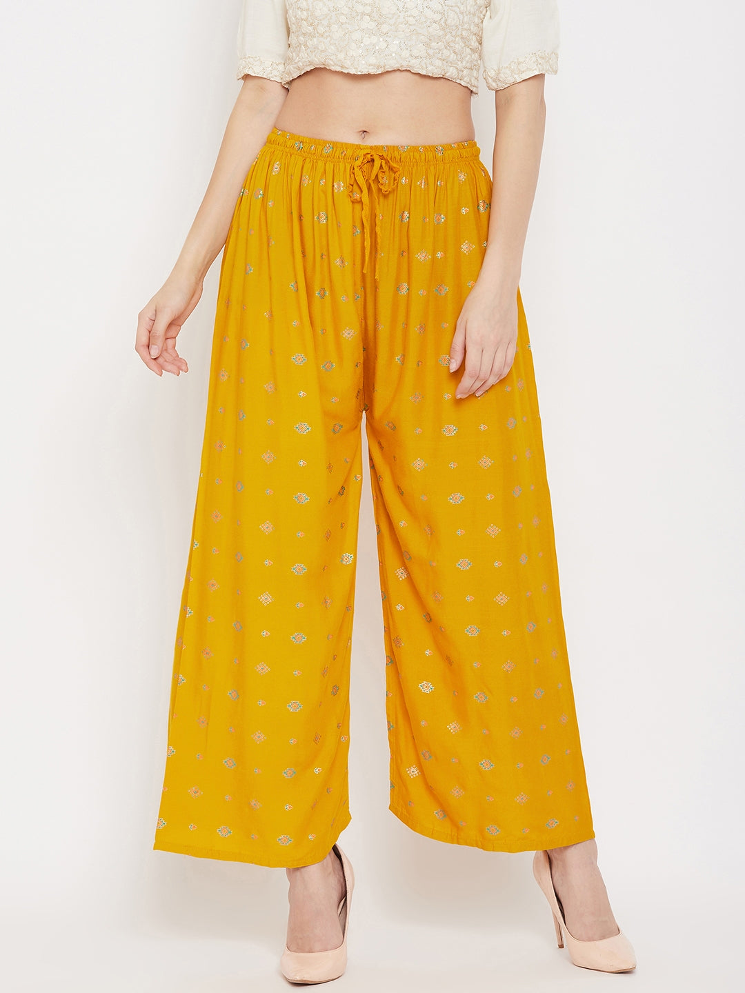 Mustard printed rayon palazzo with wide-leg design.