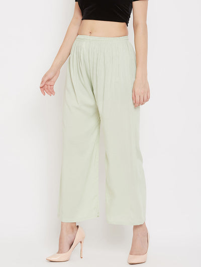 Pista green straight solid palazzo in lightweight rayon fabric.