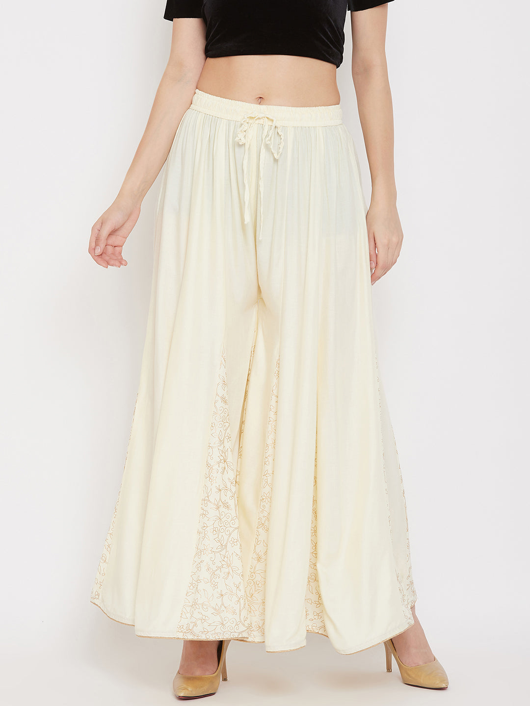 Cream printed rayon gharara with flared design and comfortable fit.