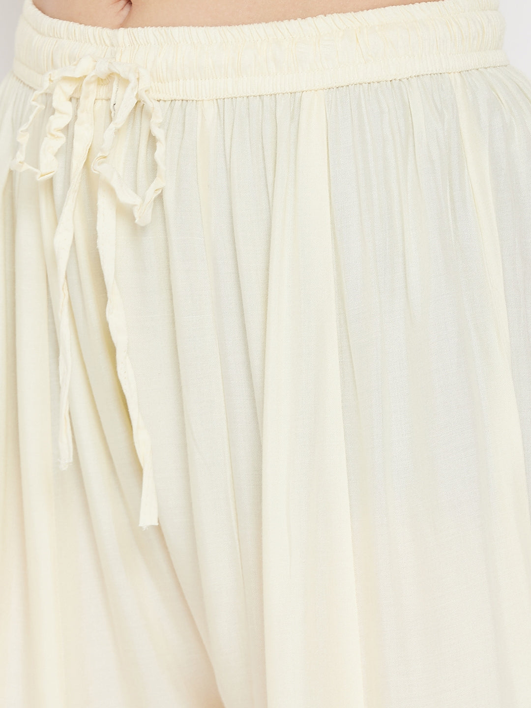 Cream printed flared rayon gharara with elastic waistband.
