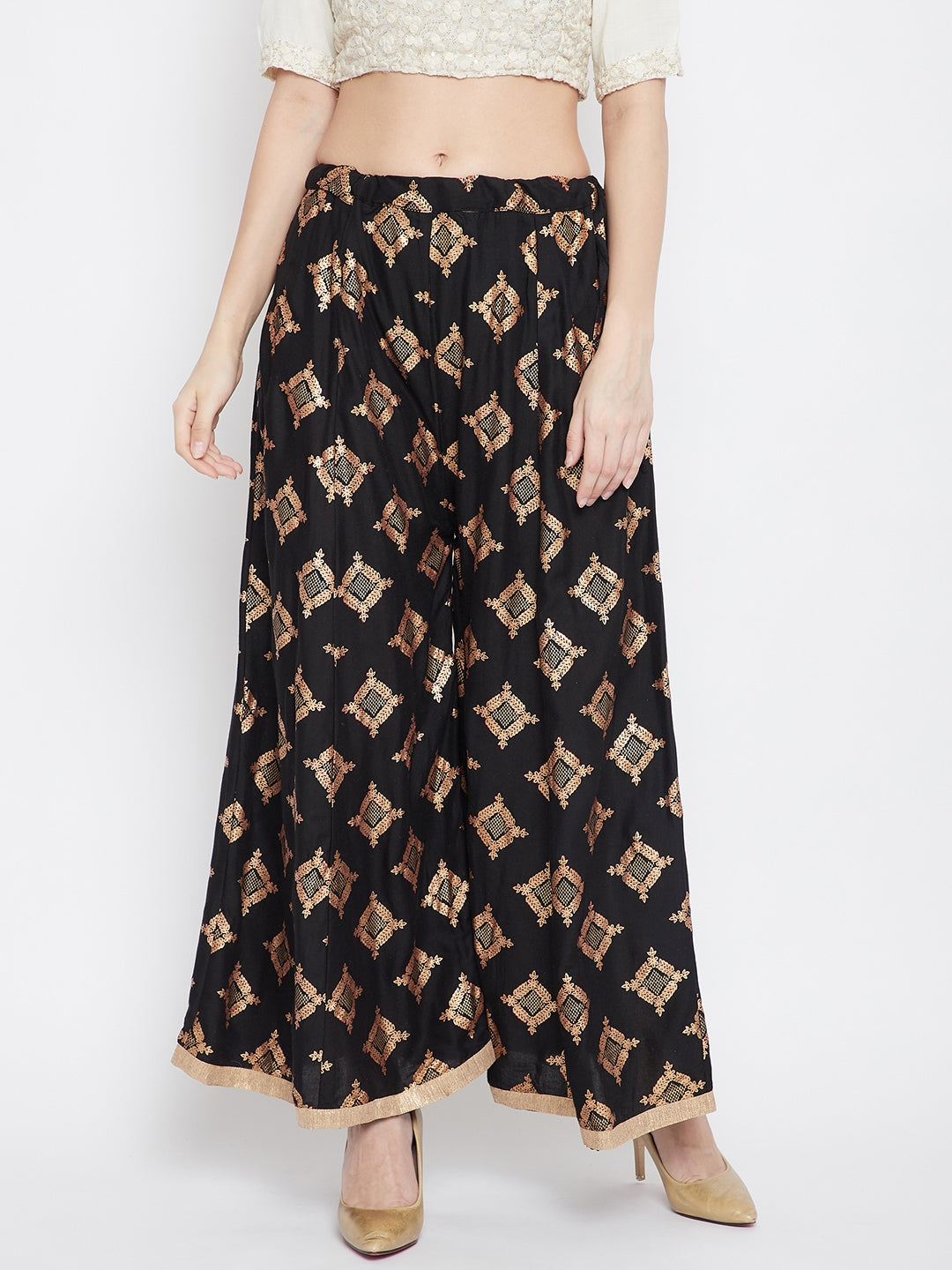 Black wide leg printed sharara with a geometric pattern, paired with beige heels.