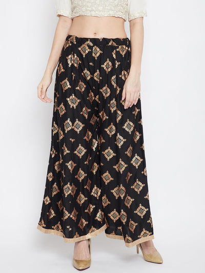 Black wide leg printed sharara with a geometric pattern, paired with beige heels.