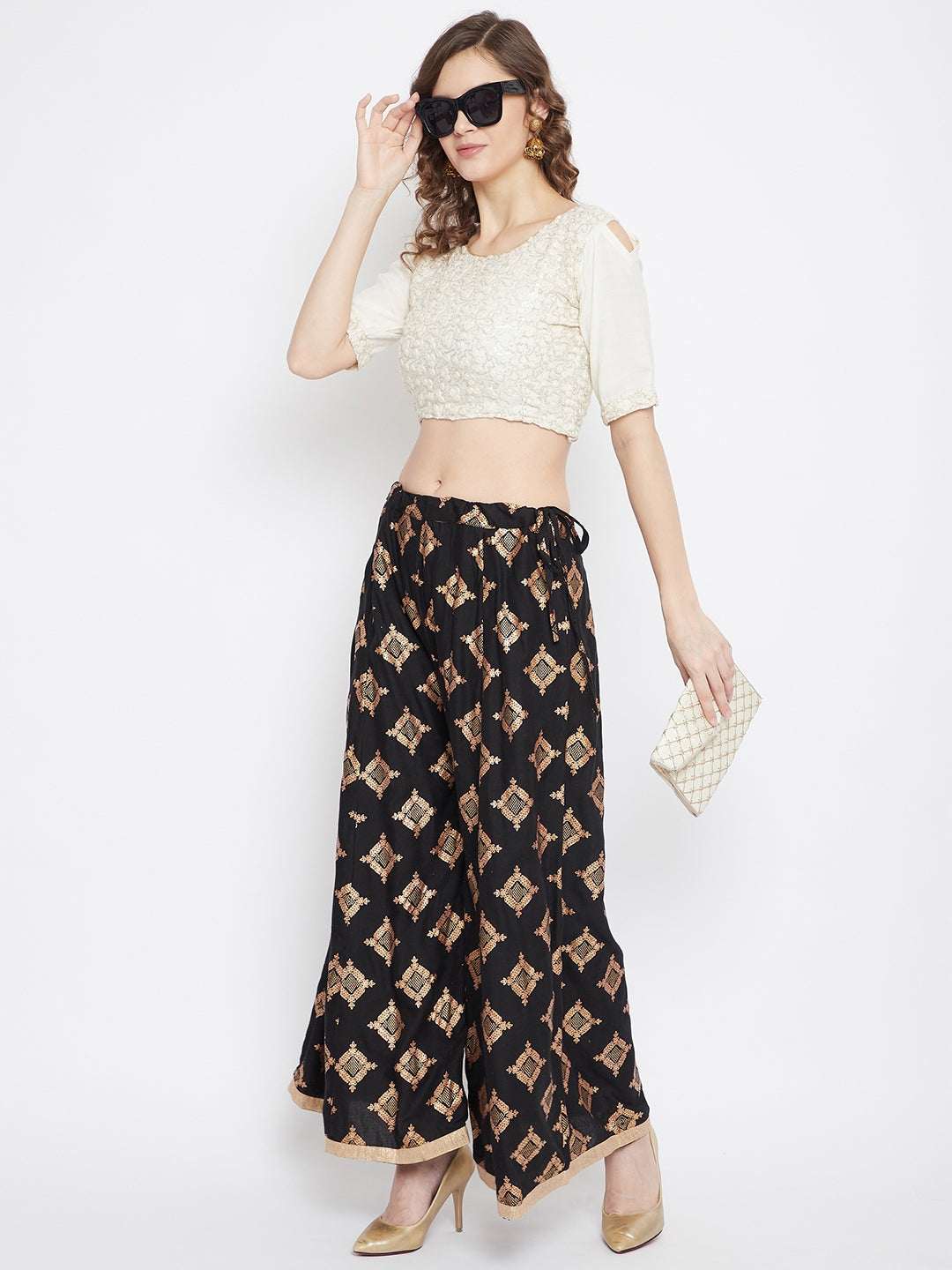 Black wide leg printed sharara with geometric pattern, styled with heels.
