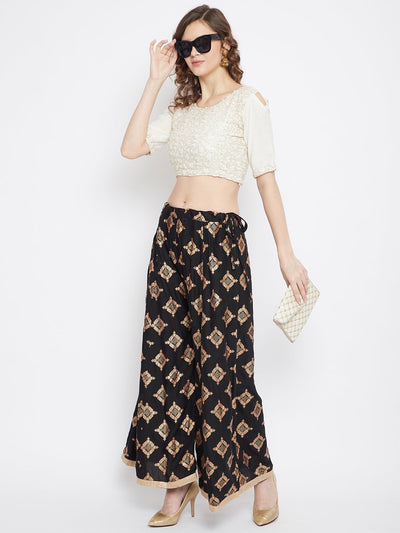 Black wide leg printed sharara with geometric pattern, styled with heels.