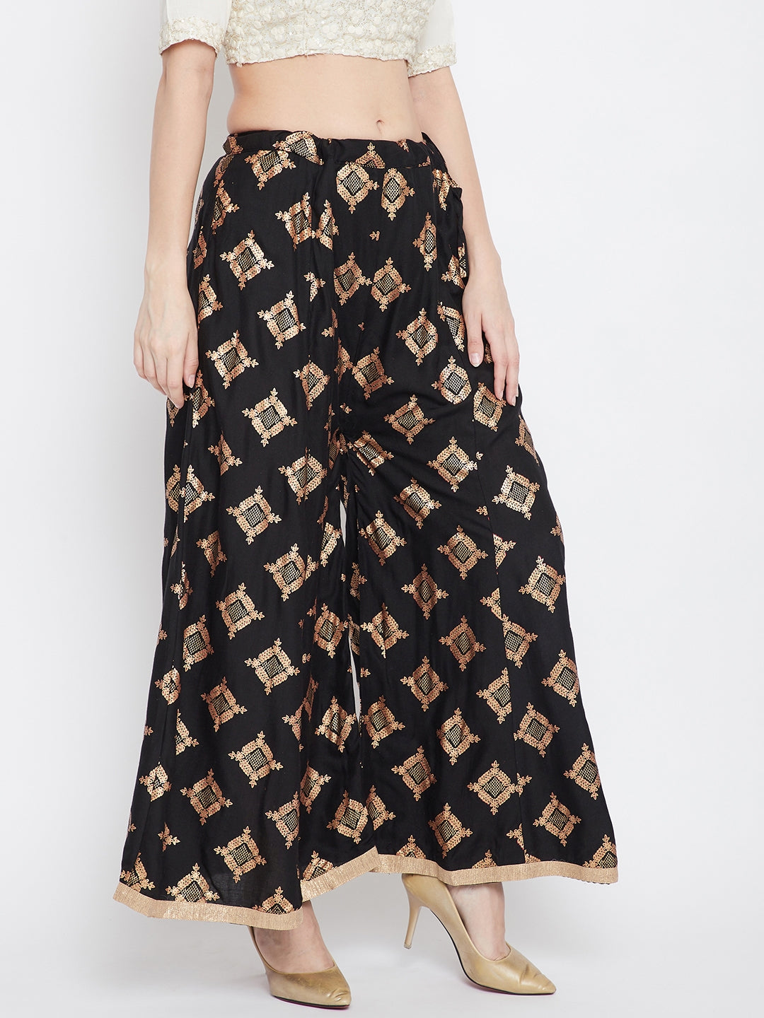 Black wide leg printed sharara pants paired with heels, stylish fashion attire.