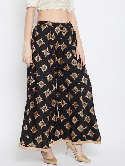 Black wide leg printed sharara pants paired with heels, stylish fashion attire.
