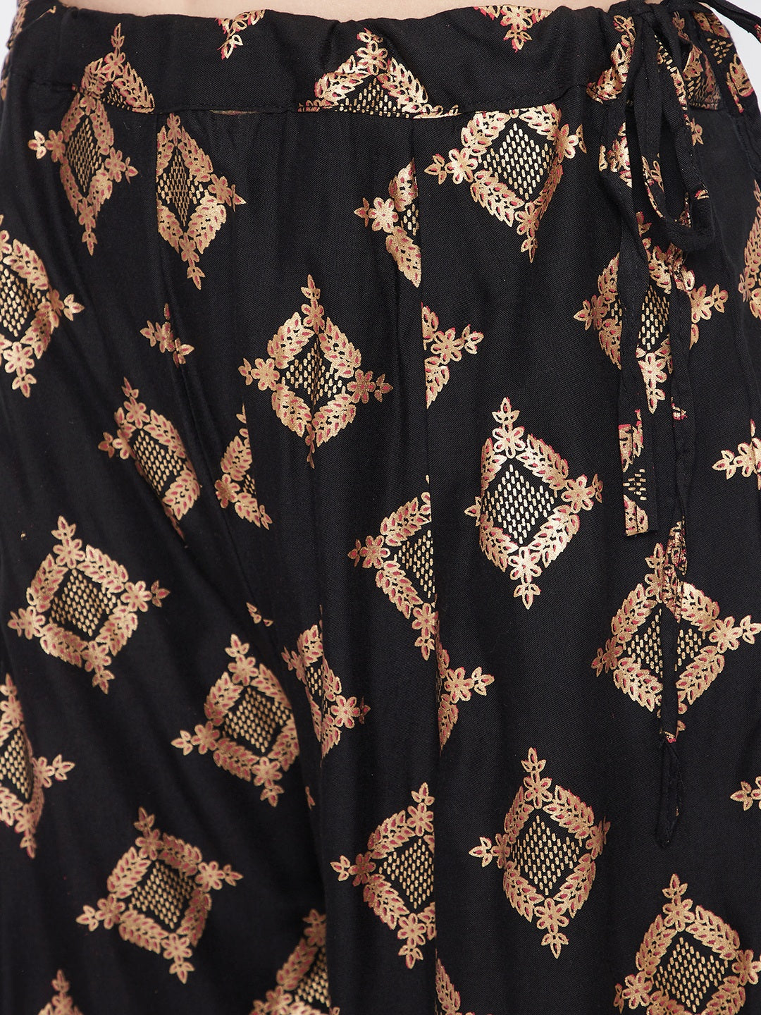 Black wide leg printed sharara with intricate gold patterns.