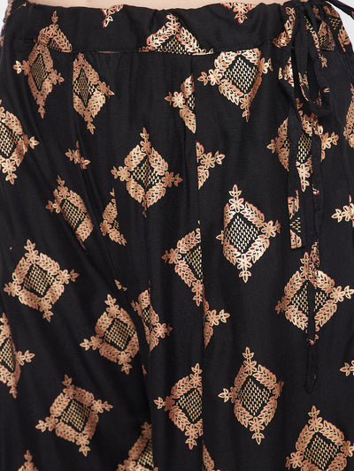 Black wide leg printed sharara with intricate gold patterns.