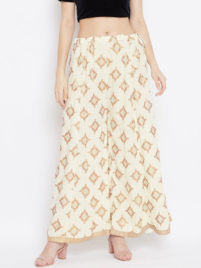 Cream wide leg printed sharara pants from Clora, styled with heels.