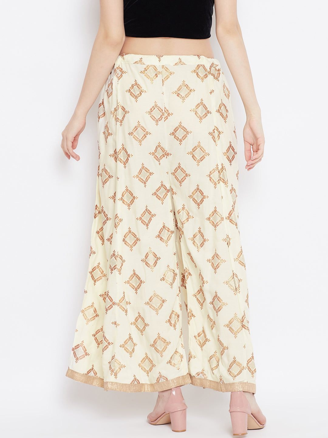 Cream wide leg printed sharara with geometric patterns, styled with heels.