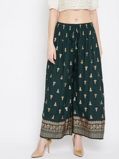 Bottle Green Printed Flared Palazzo with elegant pattern and heels.