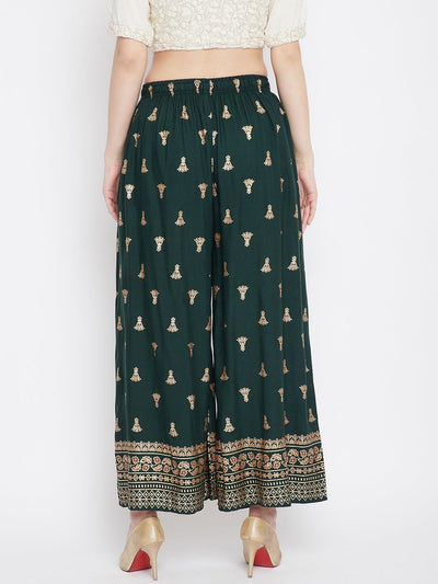 Bottle green printed flared palazzo with intricate patterns and stylish design.